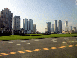 The northwest side of Xinghai Square with skyscrapers and the Dalian Xinghai Convention & Exhibition Center, viewed from the taxi