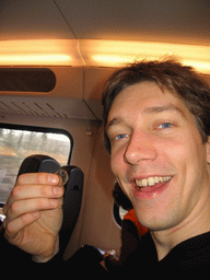 Tim with a Euro coin, in the train to Delft