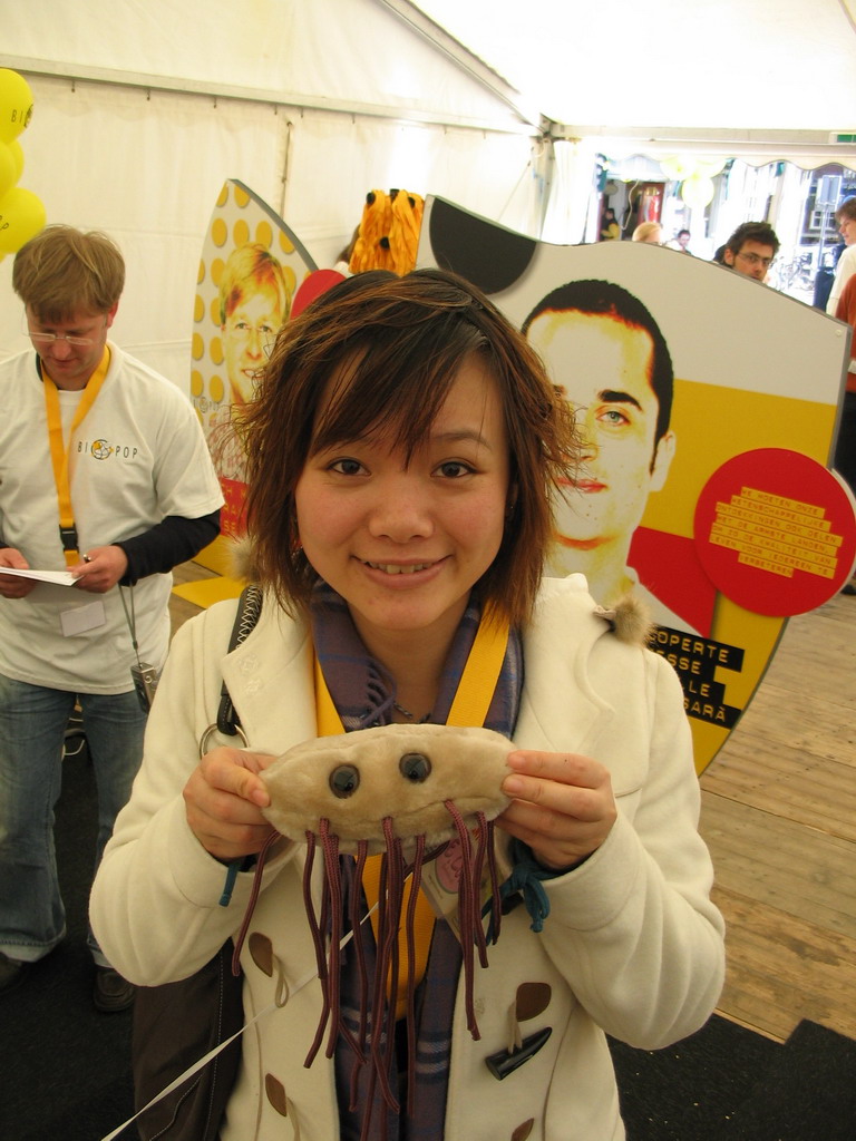 Miaomiao in the BIOPOP tent, with a plush giant microbe