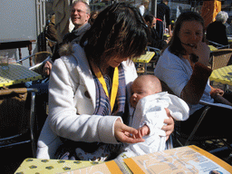 Miaomiao with a baby at a terrace on the Markt square