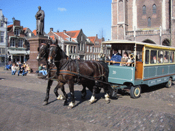 Delftse Paardentram (Delft Horse Tram), the statue of Hugo de Groot, and the Nieuwe Kerk church, on the Markt square