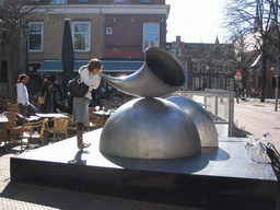 Miaomiao at the piece of art `Hoorn van Overvloed` (Horn of Plenty) at the Heilige Geest Kerkhof square