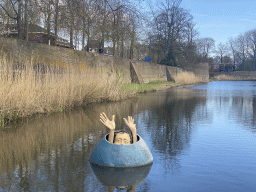 Statue of a figure from the painting `The Garden of Earthly Delights` of Hieronymus Bosch, at the west side of the Stadsgracht canal at the Zuiderpark