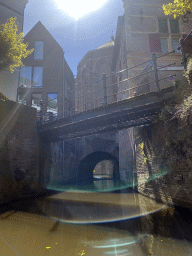 Bridge over the Binnendieze river at the Kruisbroedershof street and tunnel under the St. Catharina Church, viewed from the tour boat