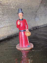 Statue in the Binnendieze river in the tunnel under the St. Catharina Church, viewed from the tour boat