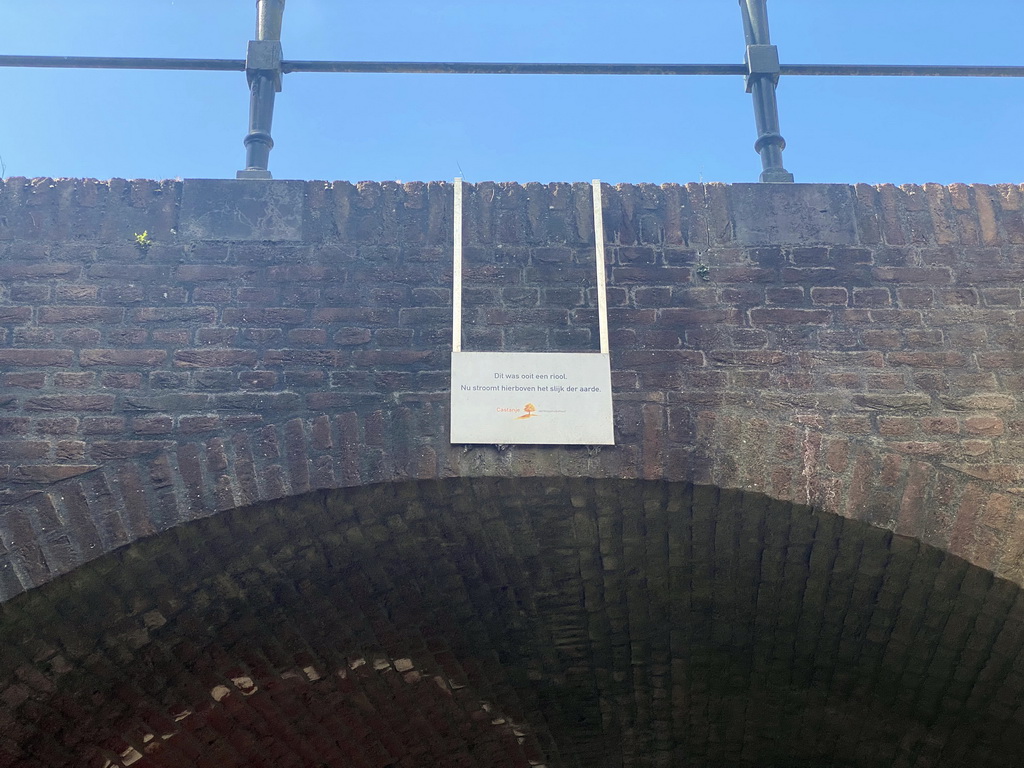Sign on a bridge over the Binnendieze canal near the Zuidwal street, viewed from the tour boat