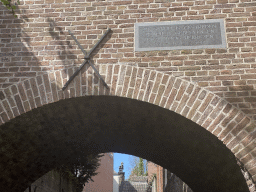 Sign on a building over the Binnendieze canal at the Beurdsestraat street, viewed from the tour boat