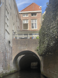Bridge and building over the Binnendieze river at the Lombardje street, viewed from the tour boat