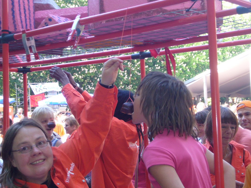 Child eating a `Bossche bol` during the Queen`s Day festivities at the Parade square