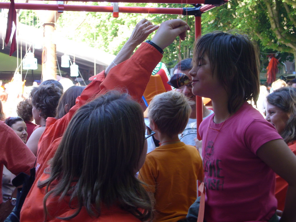 Child eating a `Bossche bol` during the Queen`s Day festivities at the Parade square