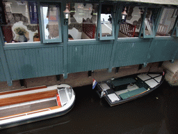 Boats in the Binnendieze river at the boarding point of the boat tour at the Molenstraat street