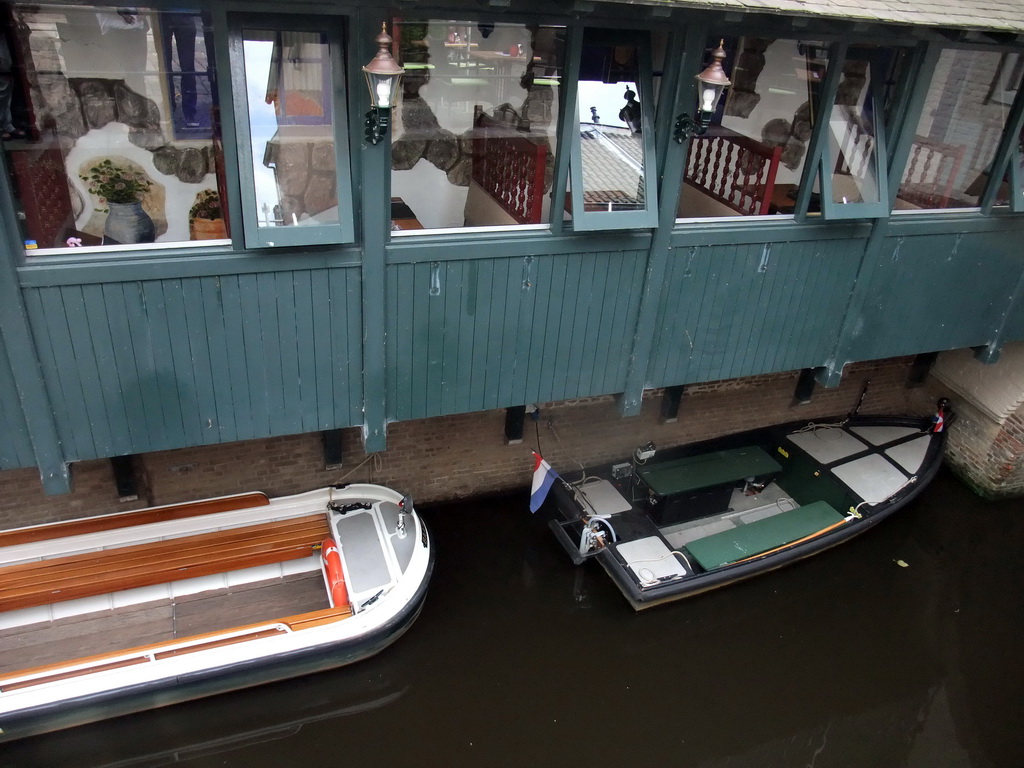 Boats in the Binnendieze river at the boarding point of the boat tour at the Molenstraat street