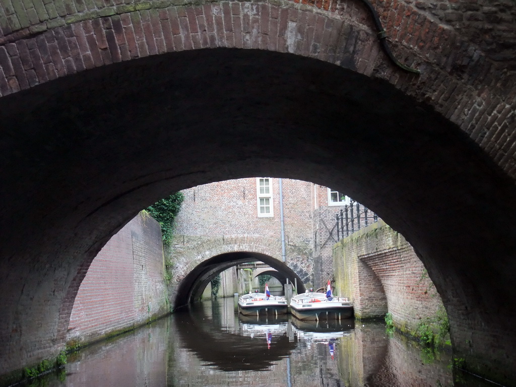 Bridges and boats in the Binnendieze river, viewed from the tour boat