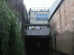 Building hanging over the Binnendieze river, viewed from the tour boat