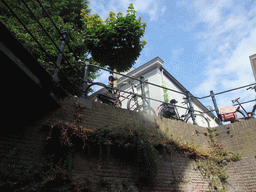 Bicycles parked at a fence alongside the Binnendieze river, viewed from the tour boat