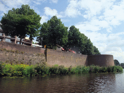 City wall at the Zuidwal street, a small bastion and the Singelgracht canal, viewed from the tour boat