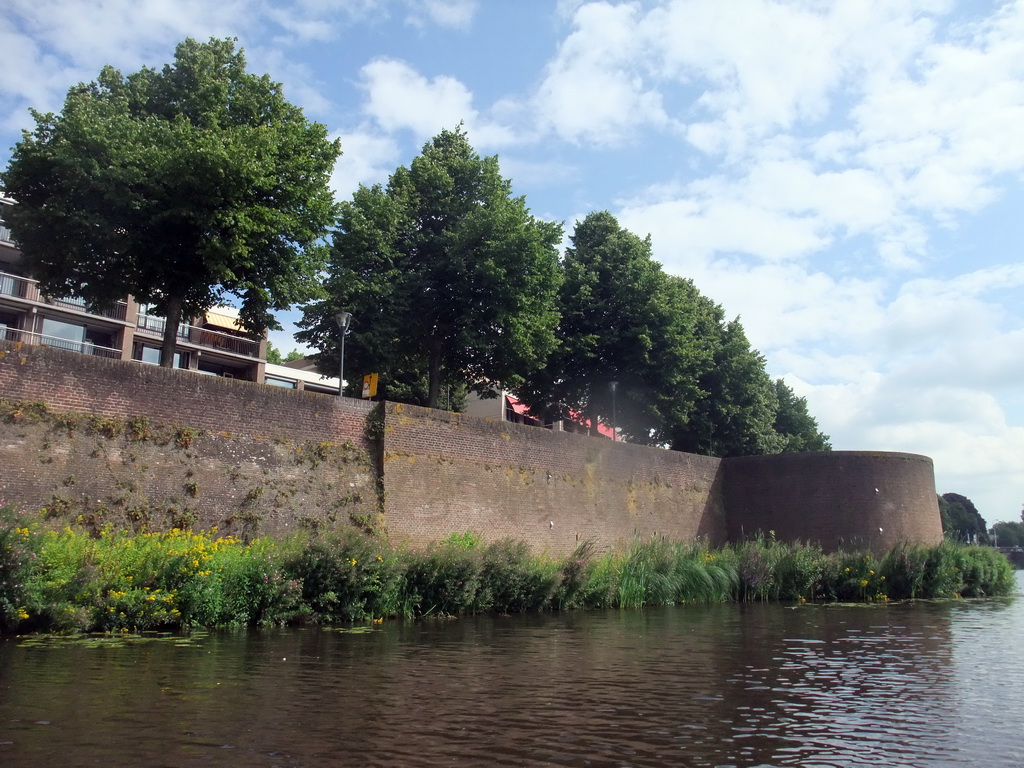City wall at the Zuidwal street, a small bastion and the Singelgracht canal, viewed from the tour boat