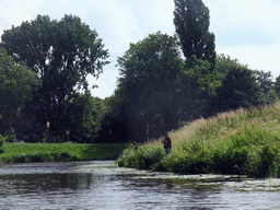 Fisherman at the Bossche Broek grassland, viewed from the tour boat on the Singelgracht canal