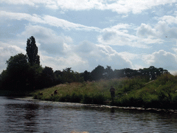 Fisherman at the Bossche Broek grassland, viewed from the tour boat on the Singelgracht canal