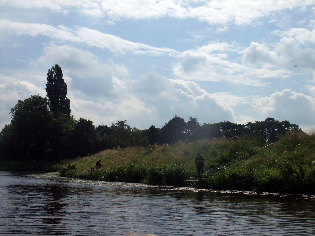 Fisherman at the Bossche Broek grassland, viewed from the tour boat on the Singelgracht canal