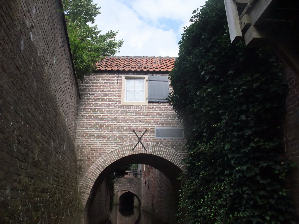 Building hanging over the Binnendieze river, viewed from the tour boat