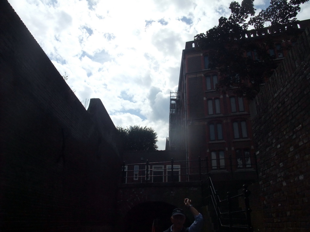 Our guide on the tour boat and buildings at the Binnendieze river