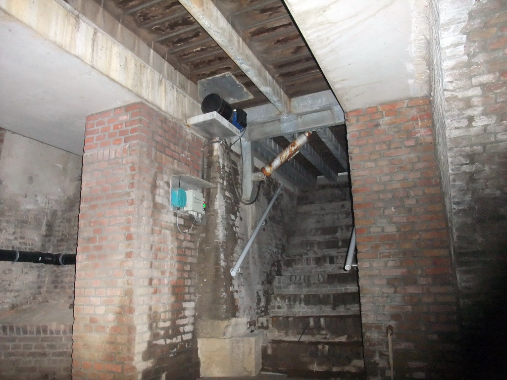 Staircase to the City Hall in a tunnel at the Binnendieze river, viewed from the tour boat