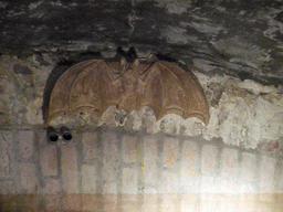 Statue of a bat in a tunnel at the Binnendieze river, viewed from the tour boat