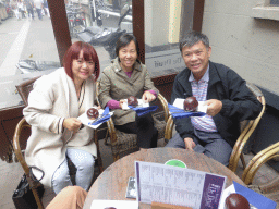 Miaomiao and her parents with Bossche Bollen at the De Druif café at the Kolperstraat street