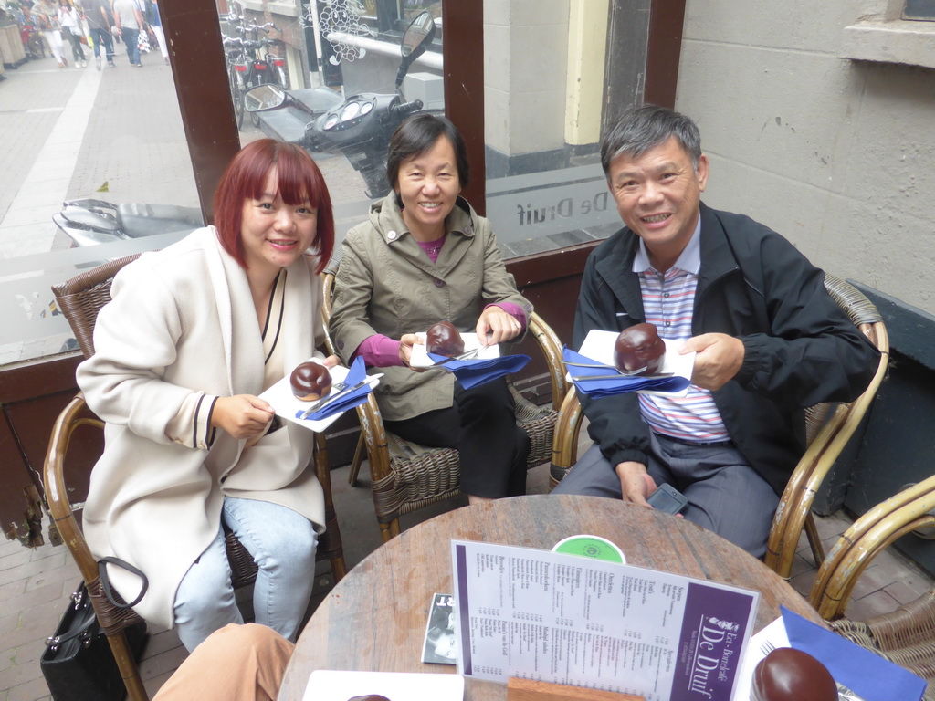 Miaomiao and her parents with Bossche Bollen at the De Druif café at the Kolperstraat street