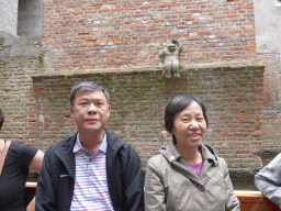 Miaomiao`s parents and the statue of a monkey, at the tour boat on the Binnendieze river