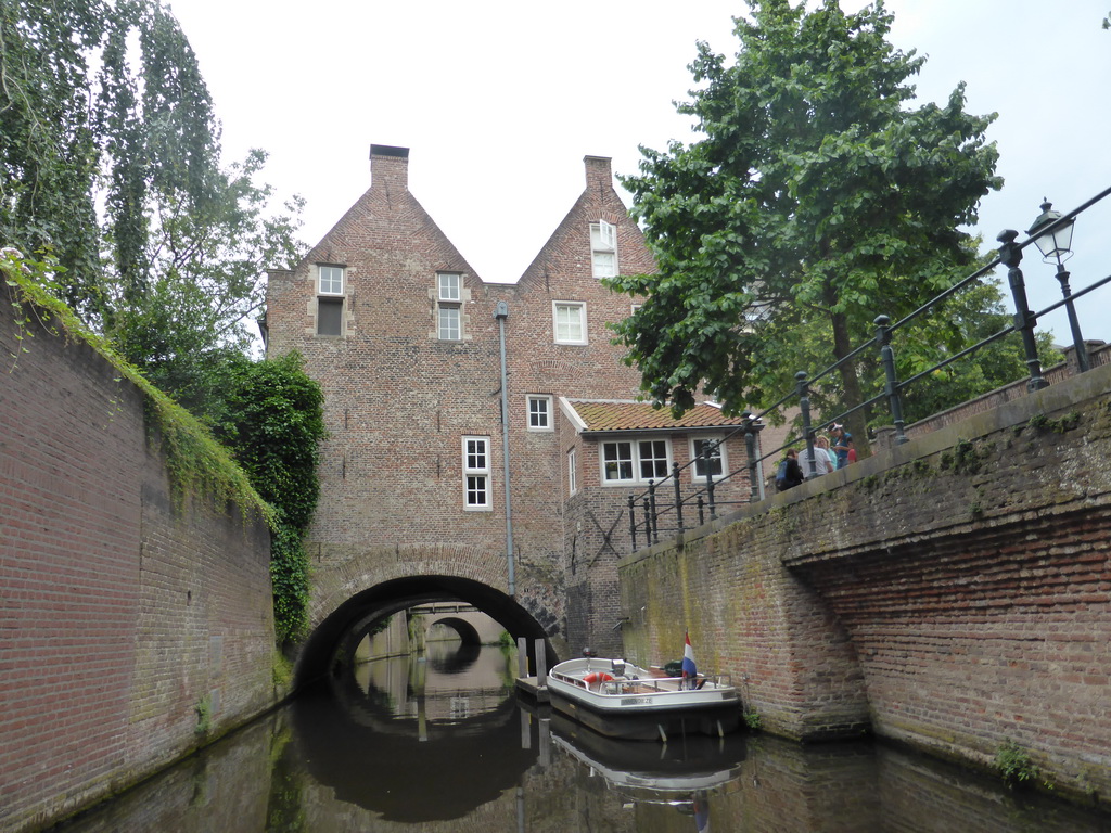 Boat and houses hanging over the Binnendieze river, viewed from the tour boat