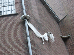 Bed sheet tied to the outer wall of a former prison, viewed from the tour boat