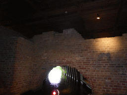 Old city wall at the Kruisbroedershekel tunnel from the Binnendieze river to the Singelgracht canal, viewed from the tour boat