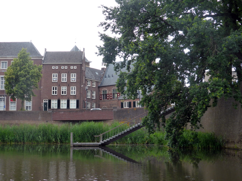 The Refugiehuis building at the Spinhuiswal street, the city wall and staircase from the Singelgracht canal, viewed from the tour boat