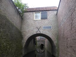 Building and bridge over the Binnendieze canal, viewed from the tour boat