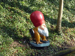Statue of a figure from a painting of Hieronymus Bosch, at the Binnendieze river at the Casinotuin garden
