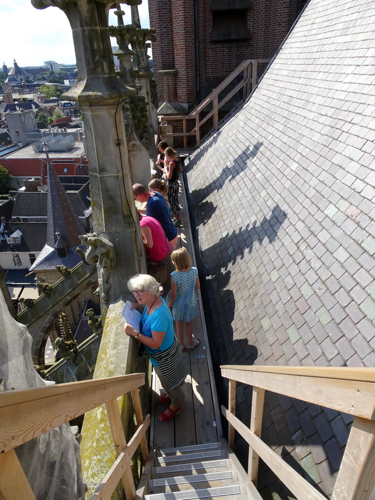 People in the gutter at the southwest side of St. John`s Cathedral, viewed from the upper platform of the `Een Wonderlijke Klim` exhibition