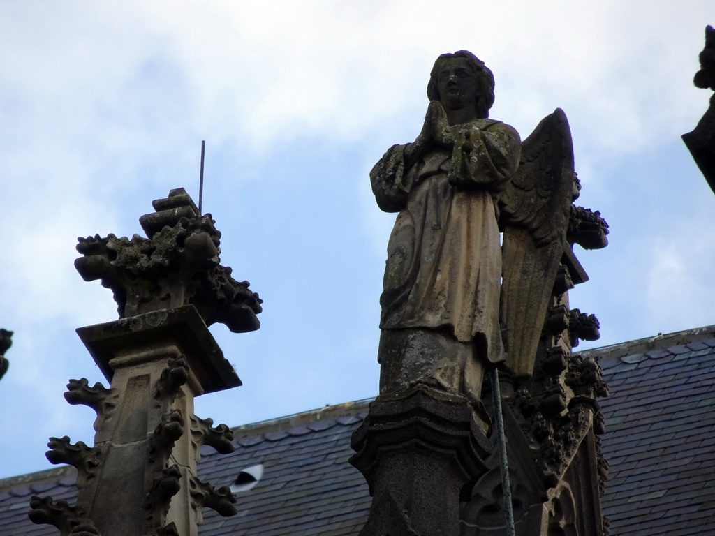 Angel statue at the north side of St. John`s Cathedral, viewed from the Torenstraat street