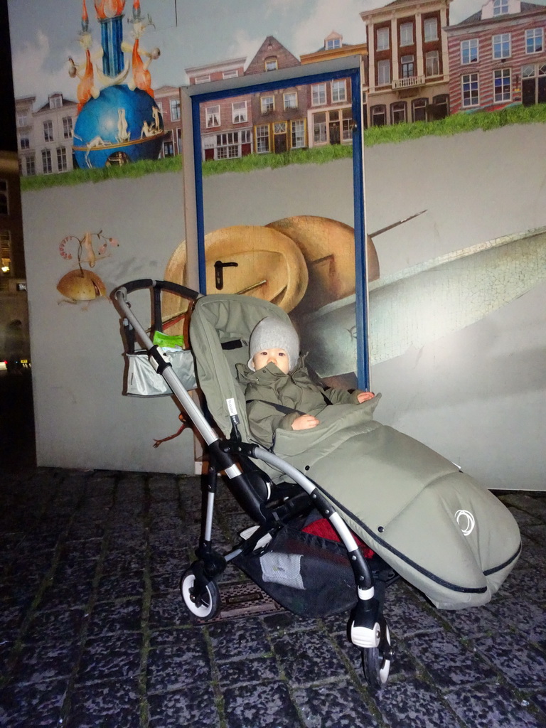 Max in front of the information stand of the `Bosch by Night` light show at the Markt square, by night