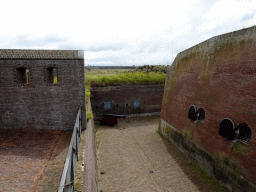 The northeast side of the moat of Fort Kijkduin with a cannon, viewed from the entrance bridge