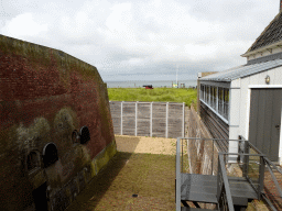 The northwest side of the moat of Fort Kijkduin with a cannon, viewed from the entrance bridge