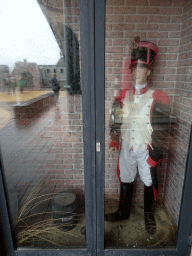 Wax statue of a soldier with a barrel of gunpowder in the lobby of Fort Kijkduin