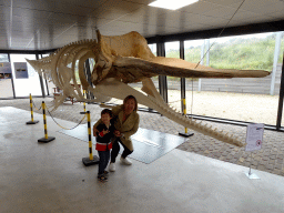 Miaomiao and Max with the skeleton of the Sperm Whale `Chris` at the Aquarium at Fort Kijkduin
