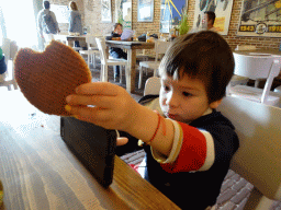 Max with a stroopwafel at the cantina at Fort Kijkduin