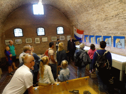 Tour guide explaining at the museum at Fort Kijkduin