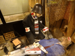 Wax statues of the air protection service giving medical aid to a wounded person at the museum at Fort Kijkduin