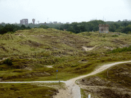 The dunes at the east side of Fort Kijkduin, with the Nieuwe Watertoren tower and the Kroontjesbunker building
