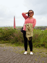Miaomiao at the east side of Fort Kijkduin, with a view on the Lange Jaap Lighthouse