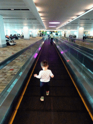 Max on the moving walkway at the Transfer Hall of Singapore Changi Airport